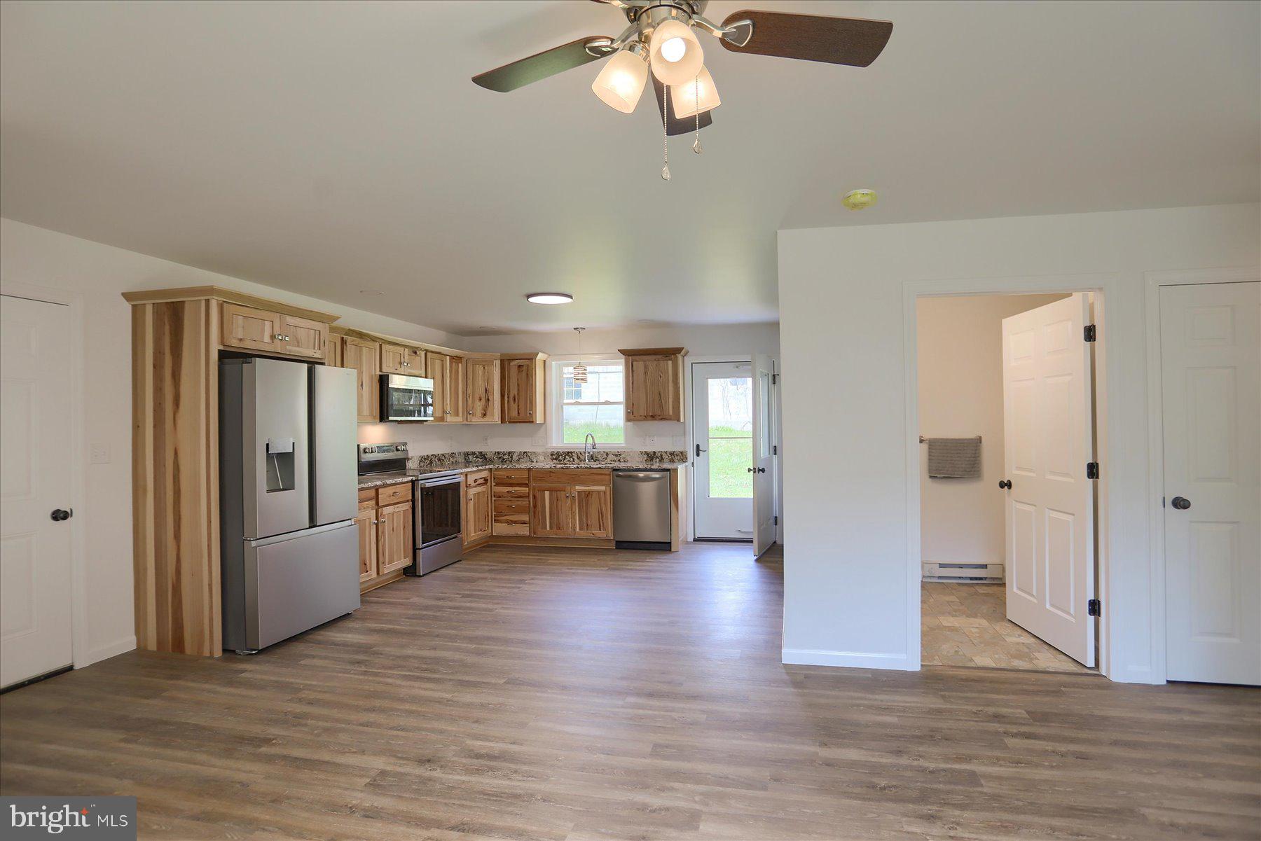 3497 New Lancaster Valley Road Milroy, PA 17063 - Photo 6 of 30 a view of a kitchen with a refrigerator and a stove top oven