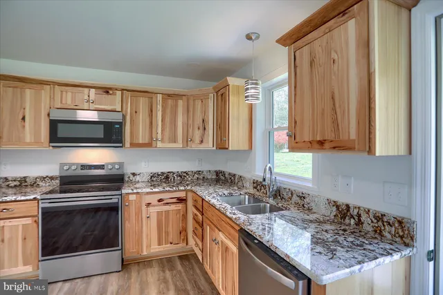 a kitchen with a sink stove and microwave