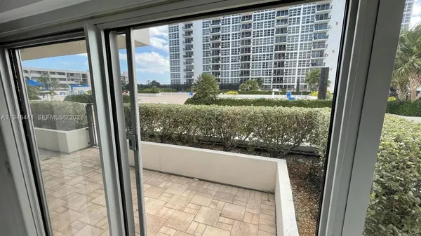 a view of a glass door and a window