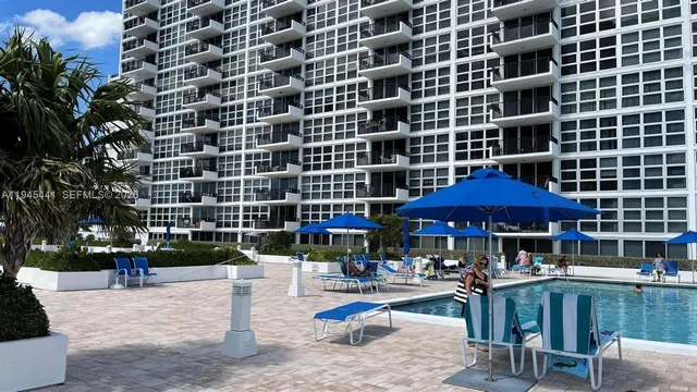 a view of a patio with a table and chairs under an umbrella