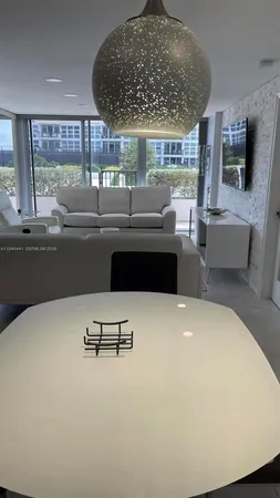 a living room with furniture and large window