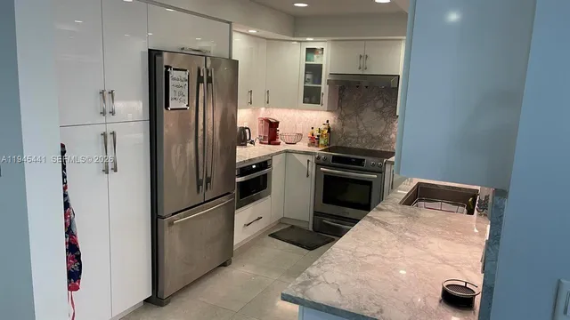 a kitchen with a refrigerator and a sink