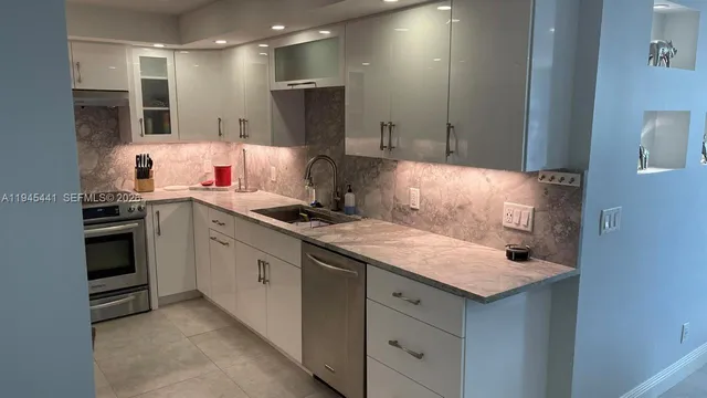 a kitchen with a sink stove and refrigerator