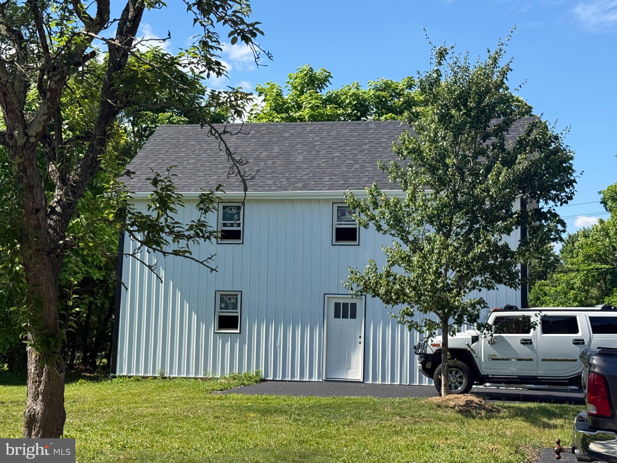 215 Mill Road Quakertown, PA 18951 - Photo 4 of 21 Charming white home amidst greenery.