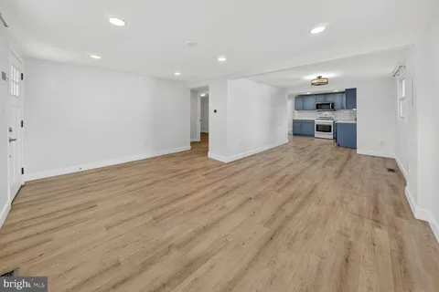 a view of a kitchen with wooden floor and a sink
