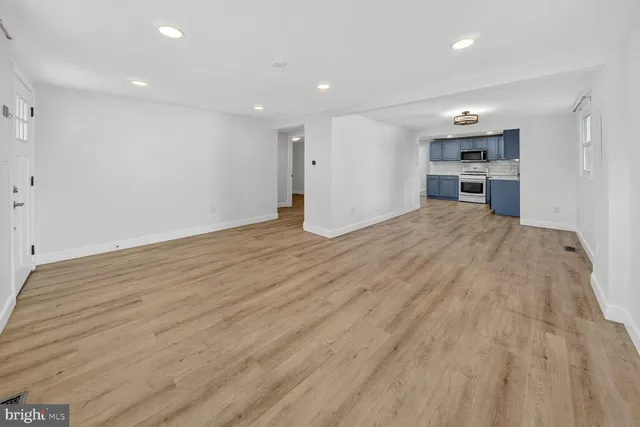 a view of a kitchen with wooden floor and a sink