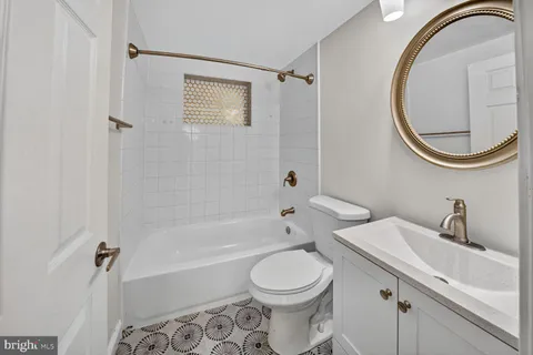 a bathroom with a toilet a sink and a mirror