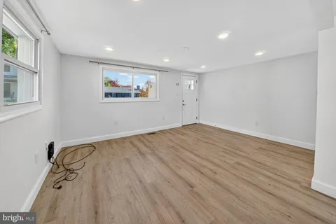 a view of room with wooden floor and window