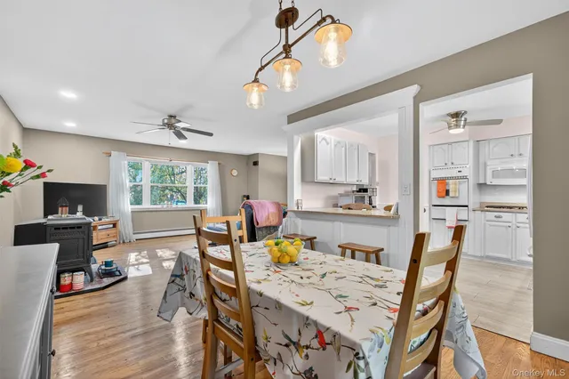 a view of a dining room with furniture and wooden floor
