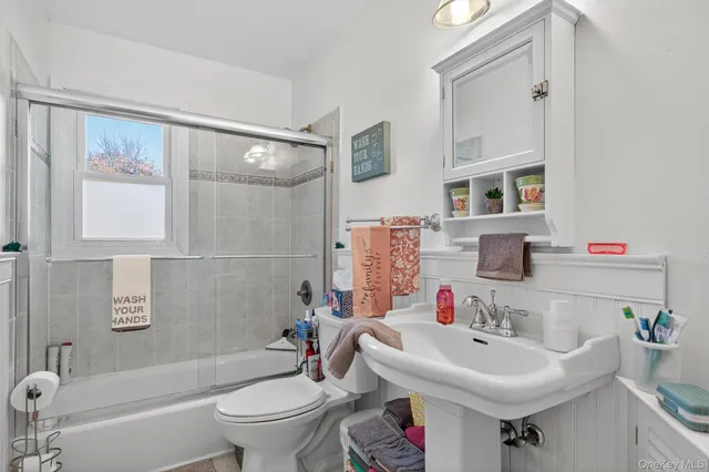 a bathroom with a sink toilet and a mirror