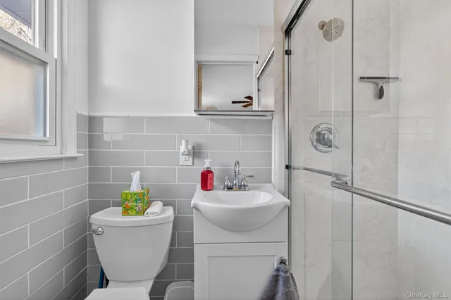 a bathroom with a sink mirror vanity and toilet