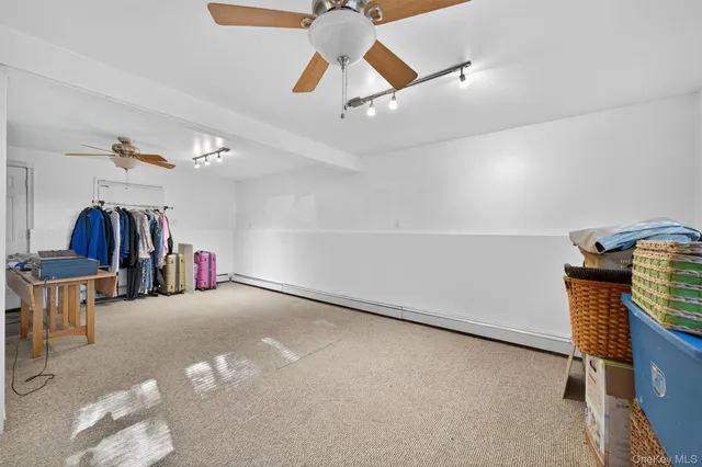 a view of room with stairs and a ceiling fan