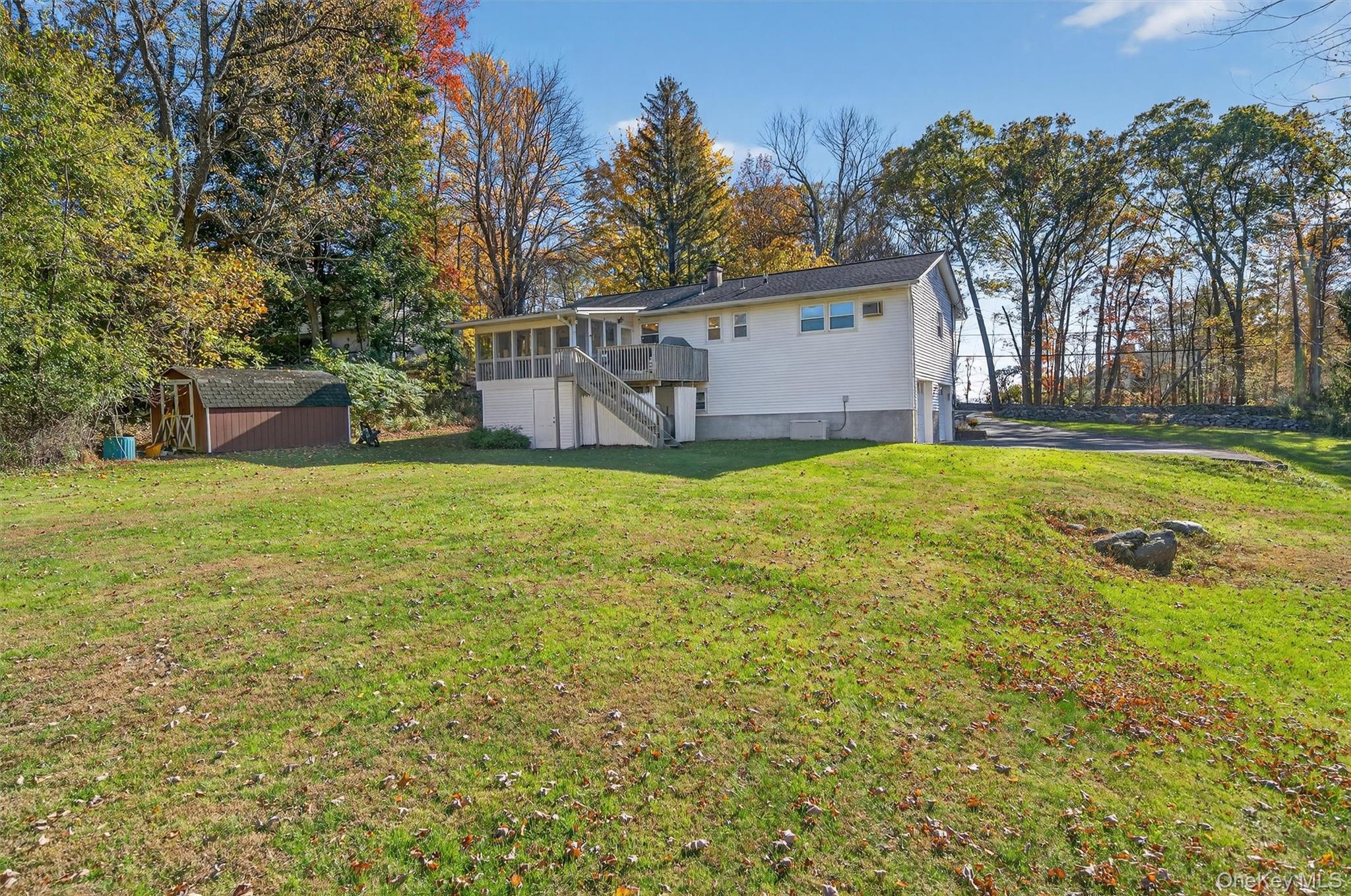 76 Pine Hill Road Highland Mills, NY 10930 - Photo 34 of 41 Rear view of house with stairway, a shed, a yard, and view of scattered trees