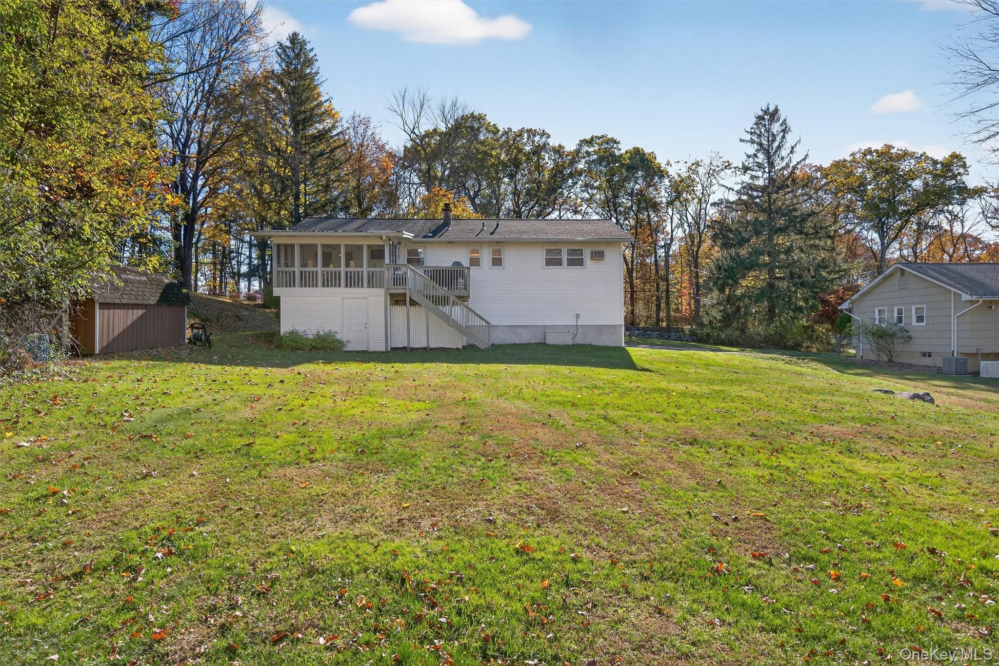 76 Pine Hill Road Highland Mills, NY 10930 - Photo 35 of 41 Back of property featuring a sunroom, a lawn, a chimney, and stairs