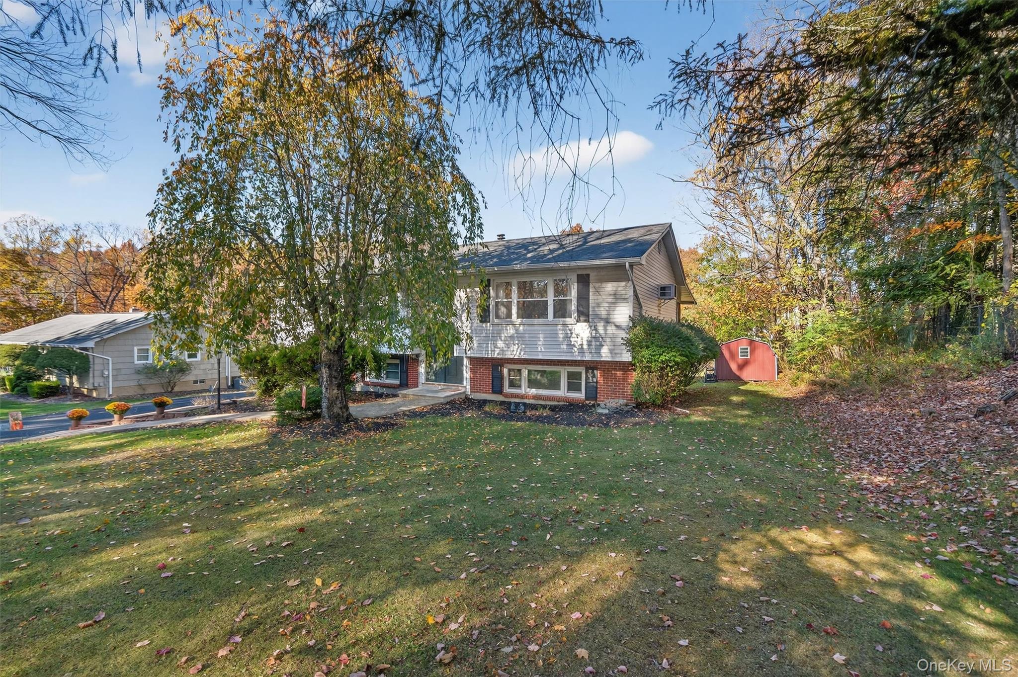 76 Pine Hill Road Highland Mills, NY 10930 - Photo 4 of 41 View of front of home featuring brick siding, a front yard, and a shed