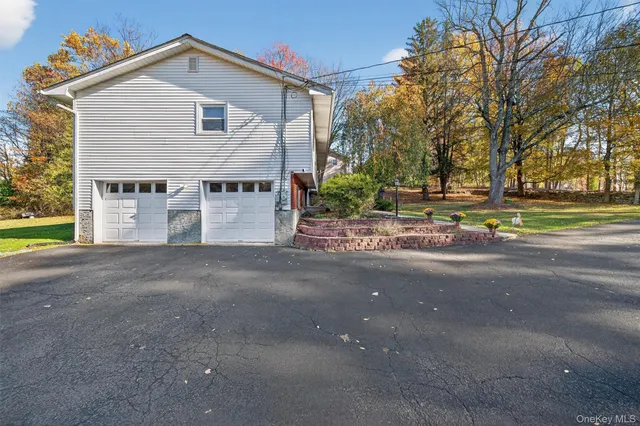 a view of a house next to a road and yard