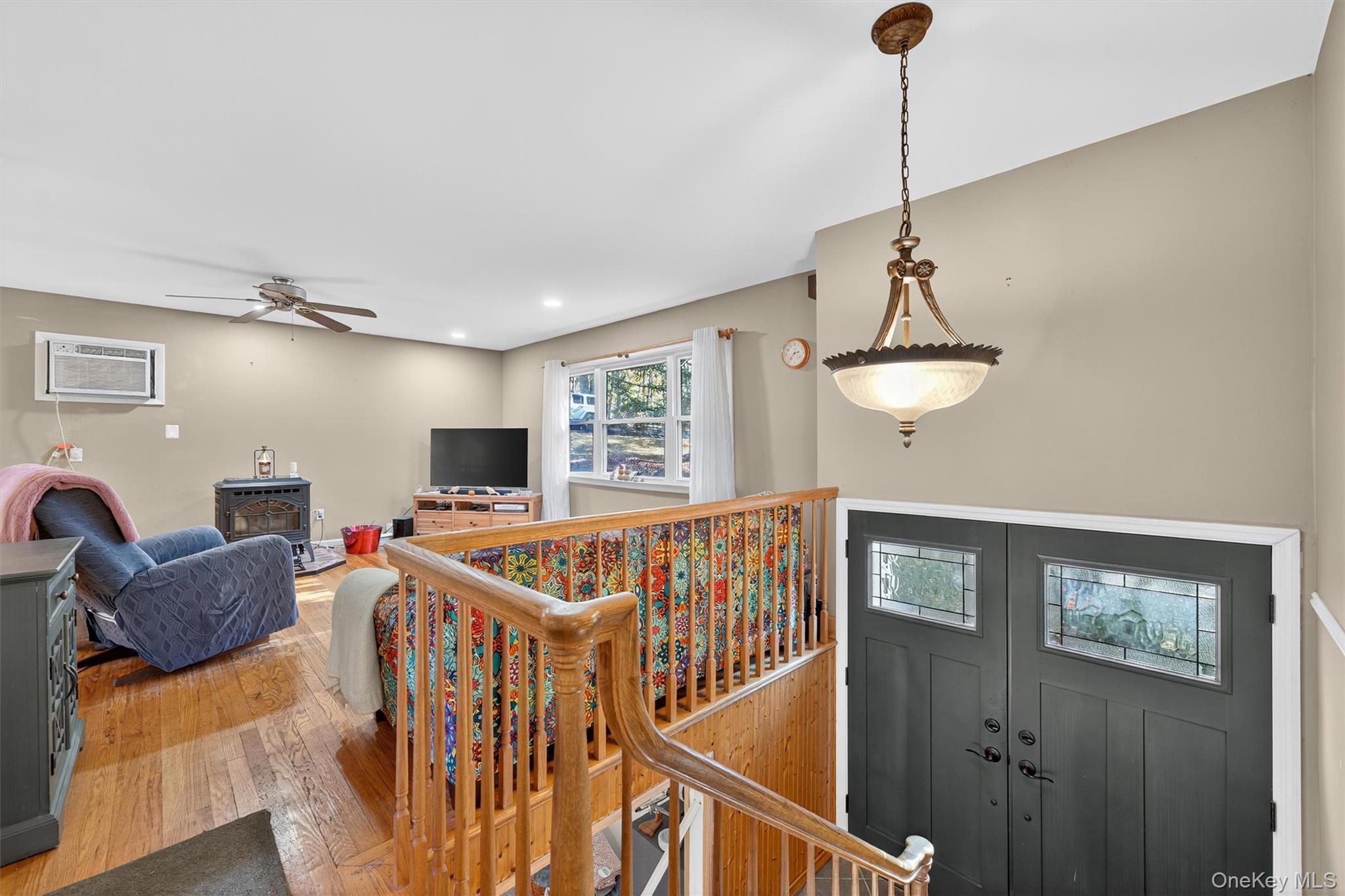 76 Pine Hill Road Highland Mills, NY 10930 - Photo 8 of 41 Foyer entrance with a wood stove, hardwood / wood-style flooring, a wall unit AC, recessed lighting, and a ceiling fan