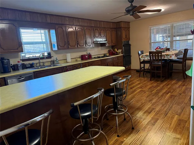 a kitchen with a table chairs stove and cabinets