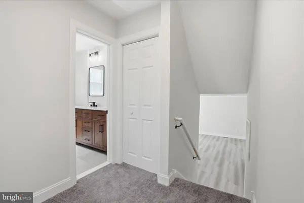 a view of a hallway with closet and cabinet