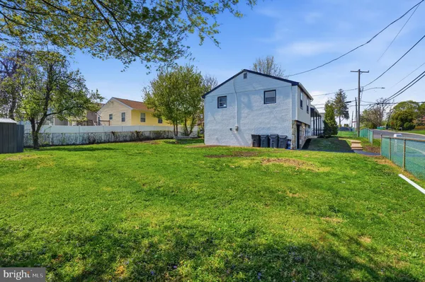 a front view of house with yard and trees