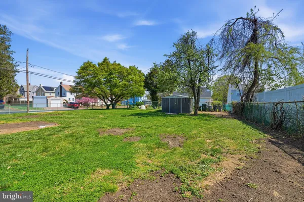a view of yard with swimming pool and green space