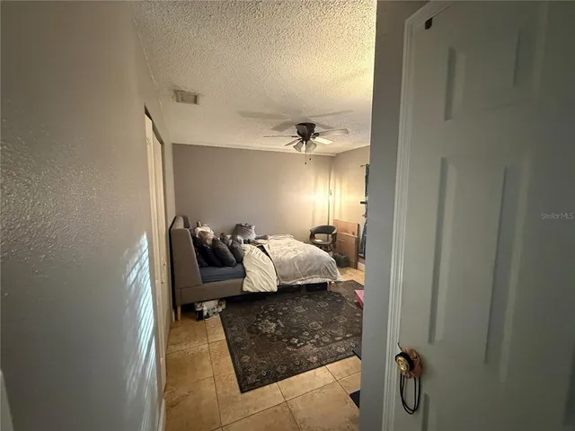 a bed room with a bed and a mirror