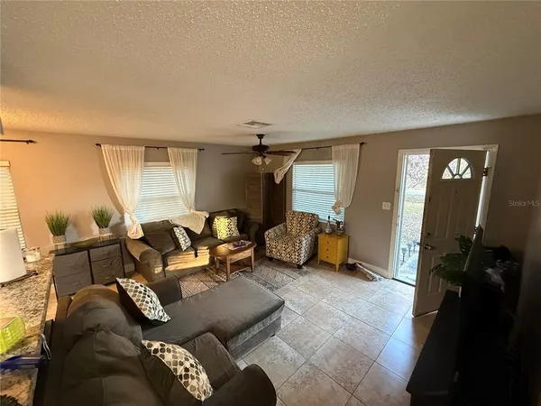 a living room with furniture and a mirror
