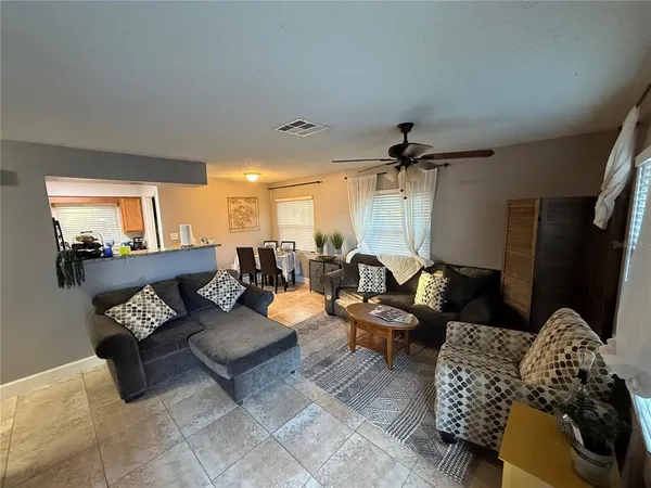 a living room with furniture and a chandelier