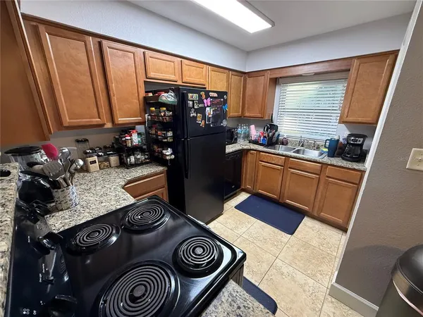 a kitchen with a sink stove and cabinets