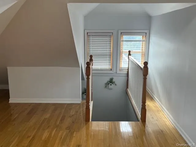 a view of a room with wooden floor and window