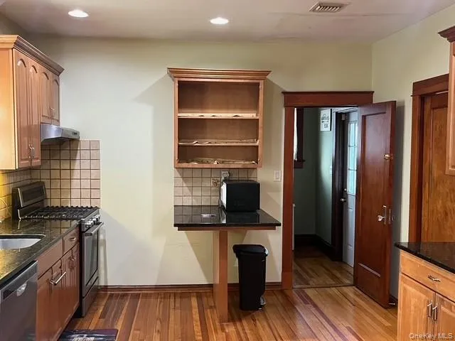 a hallway with wooden floor windows and hallway