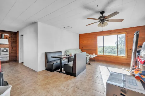 view of living room with furniture and floor to ceiling window