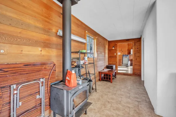a view of a hallway with wooden floor and windows
