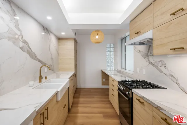 a kitchen with granite countertop a sink and a stove