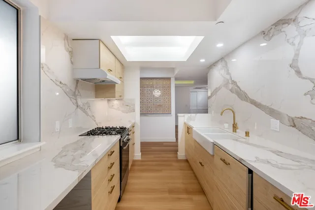 a large kitchen with a stove and a sink