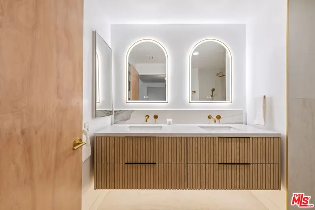 a bathroom with a double vanity sink and mirror