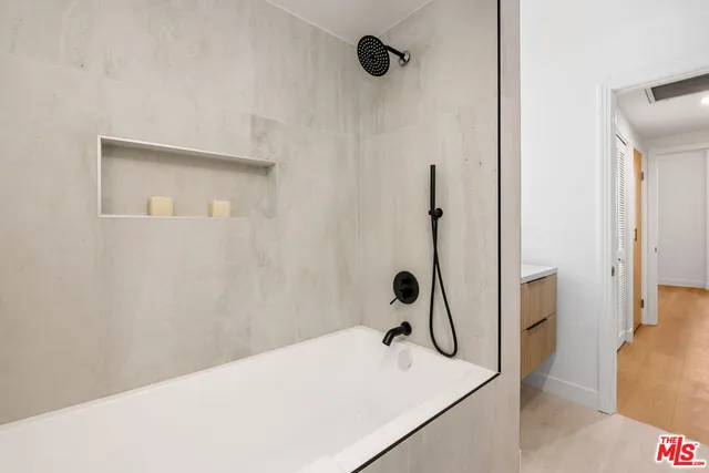 a bathroom with a tub and a shower