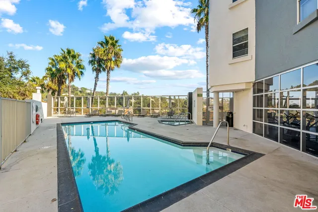 a view of a swimming pool with a lounge chairs