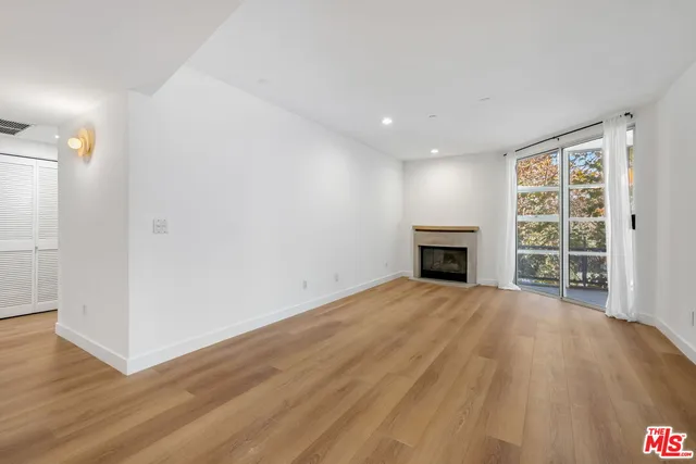 wooden floor in an empty room with a fireplace