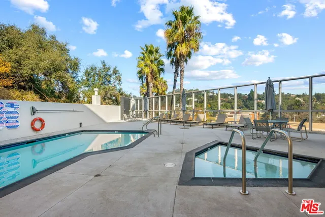 a view of a swimming pool with a patio and a garden