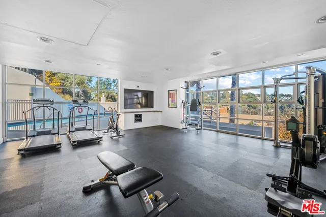 a room with gym equipment and a large window