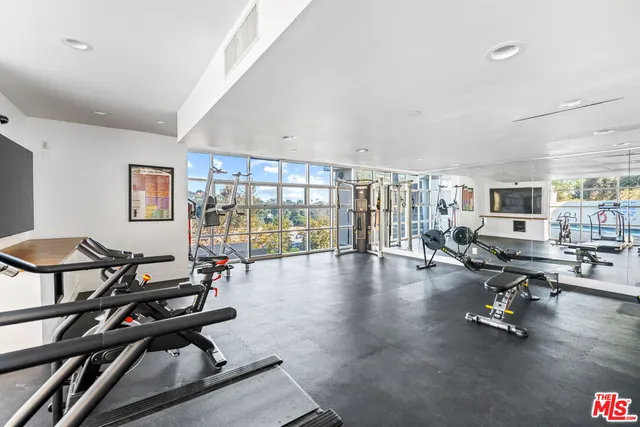 a view of a livingroom with workspace and a window