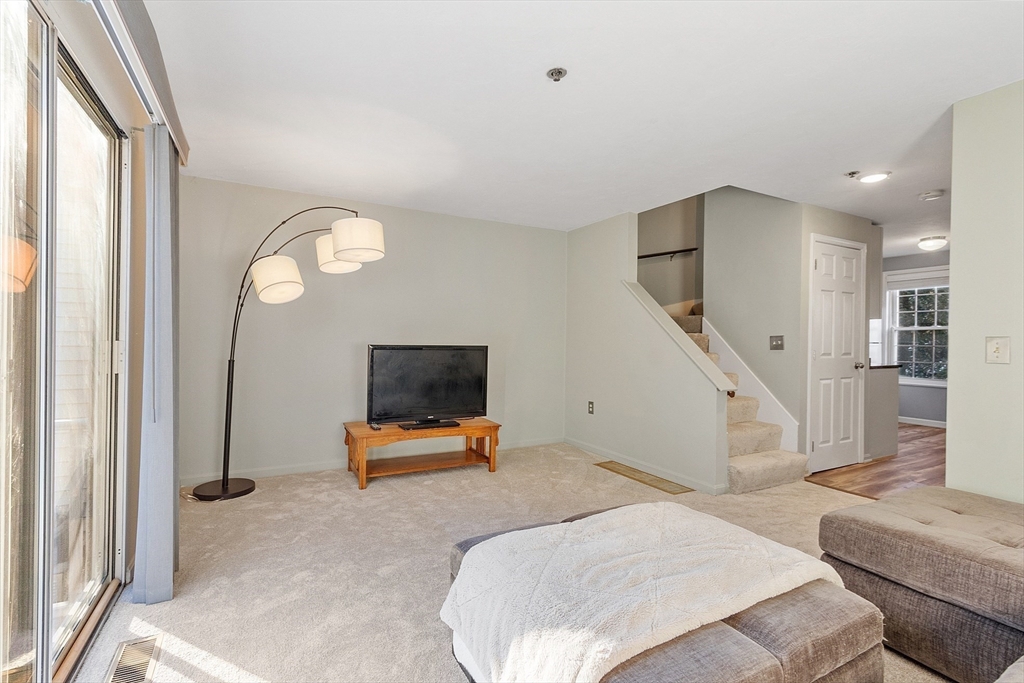 278 Manning Street, Unit 603 Hudson, MA 01749 - Photo 11 of 34 a bedroom with furniture and a mirror