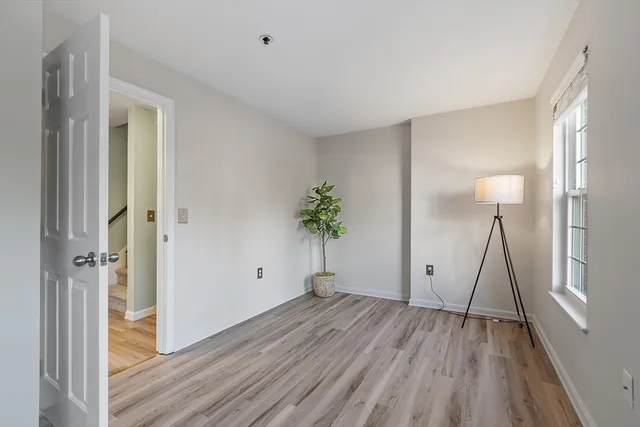 a view of room with wooden floor and stairs