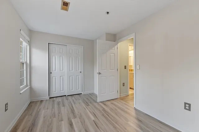 a view of an empty room with wooden floor