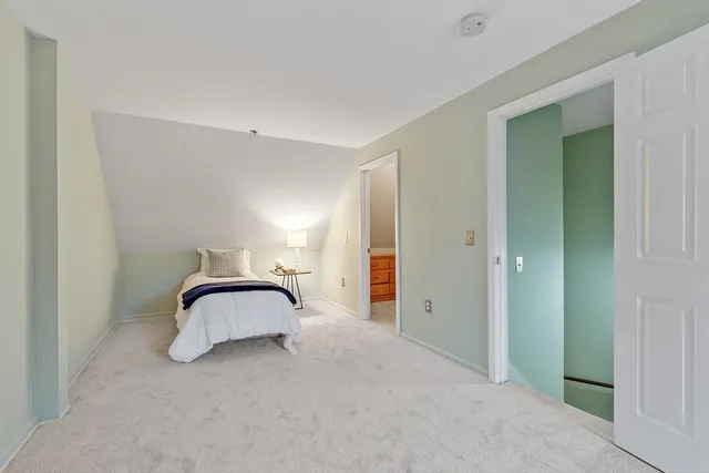 a bedroom with a bed and a lamp