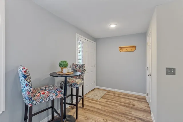 a view of a room with furniture and wooden floor