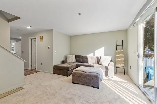 a large bedroom with a bed and a large window