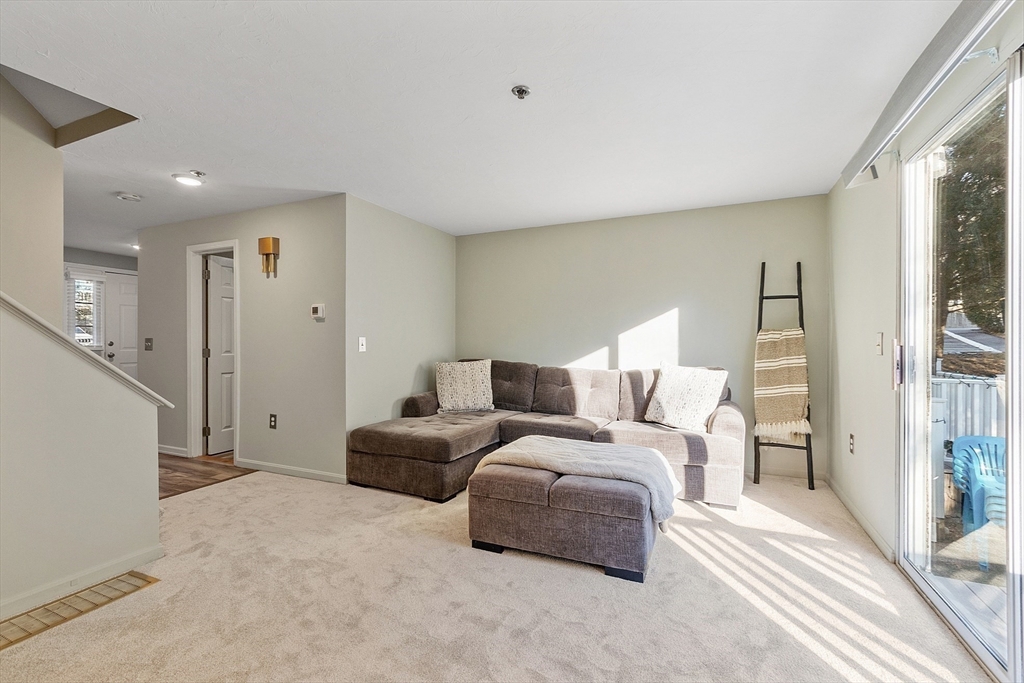 278 Manning Street, Unit 603 Hudson, MA 01749 - Photo 10 of 34 a large bedroom with a bed and a large window