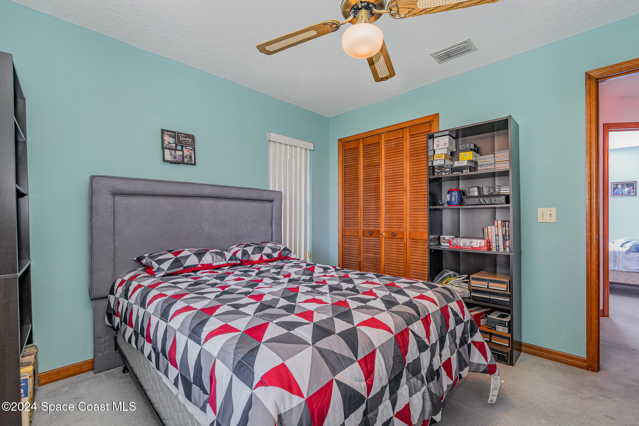 6333 Irving Road Cocoa, FL 32927 - Photo 17 of 26 a bedroom with a bed and dresser